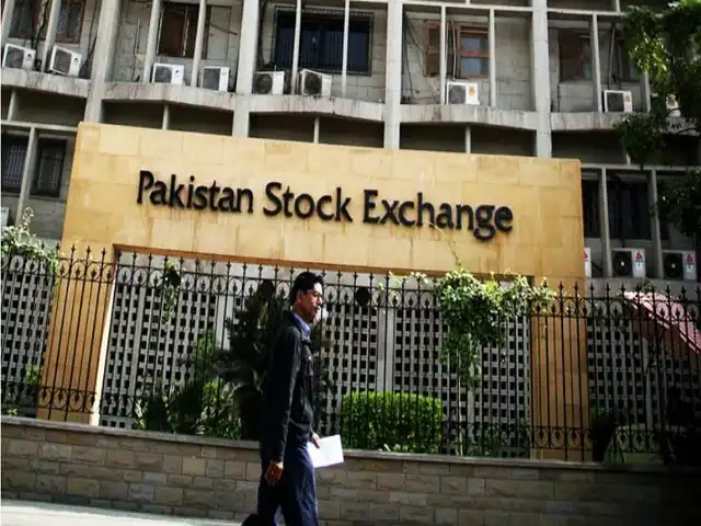 A person is walking in front of Pakistan Stock Exchange Photo Dawn News 640x480